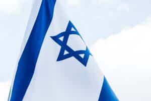 national israel flag with star of david against blue sky